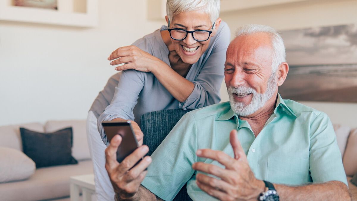 Smiling couple using phone