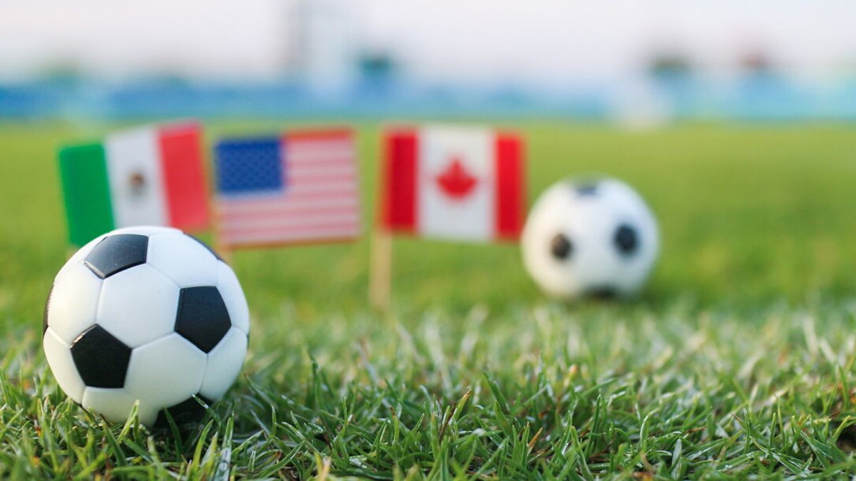 Classic football with soft flags background representing international competition and pride