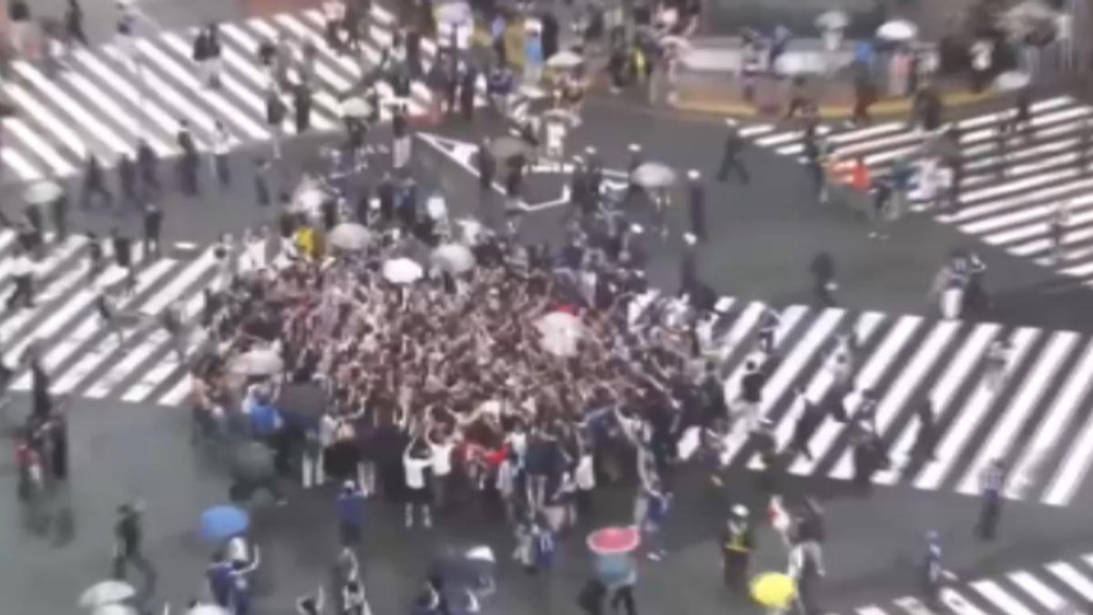 Il festeggiamento composto dei giapponesi all'incrocio di Shibuya