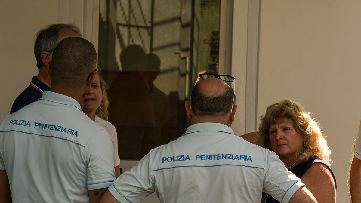 Mario Roggero (a sx, nascosto dall'agente) e la moglie Mariangela Sandrone all'ingresso del carcere di Bollate 