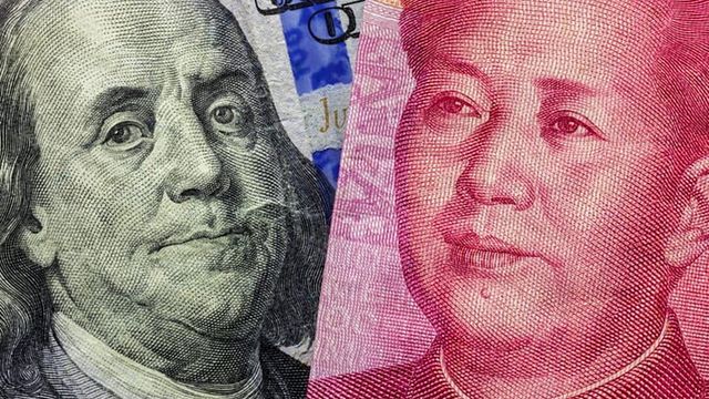  | Close up of one hundred Dollar and 100 Yaun banknotes with focus on portraits of Benjamin Franklin and Mao Tse-tung/USA vs China trade war concept