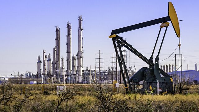 | Pumpjack (oil derrick) and refinery plant in West Texas