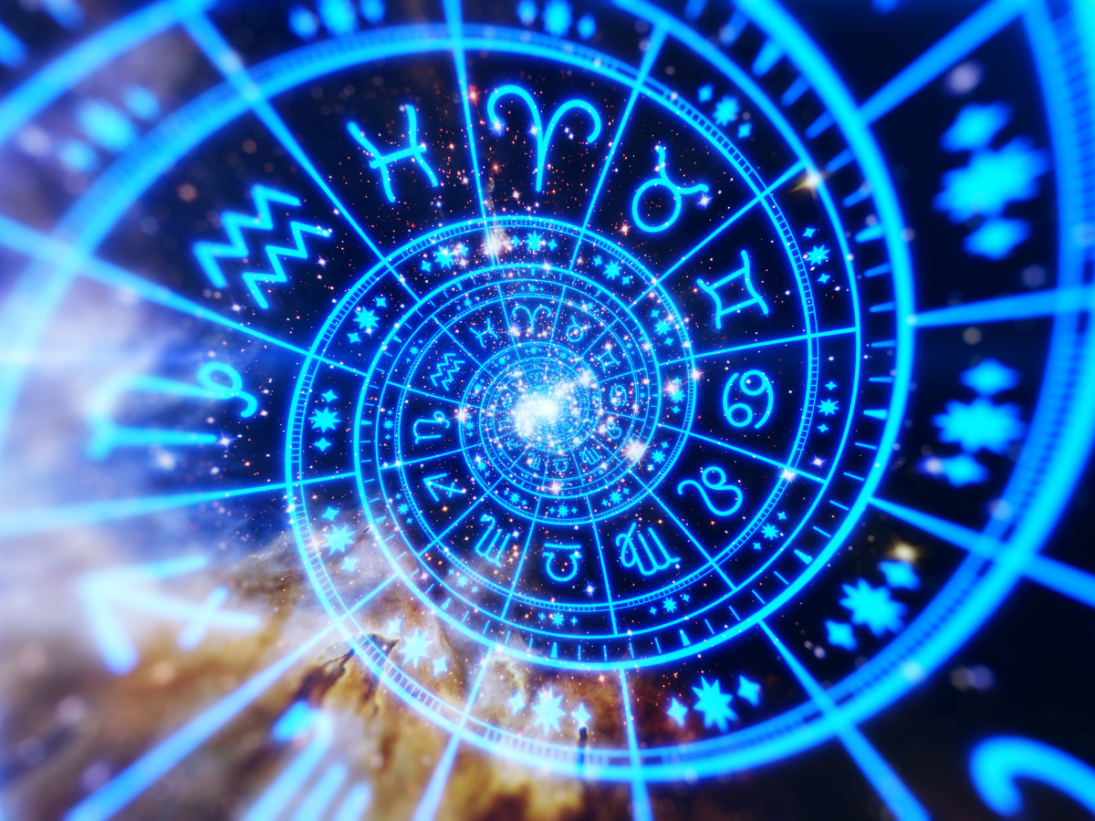 Blue neon zodiac wheel with concentric rings and zodiac glyphs surrounded by stars and cosmic light patterns, conveying astrology theme.