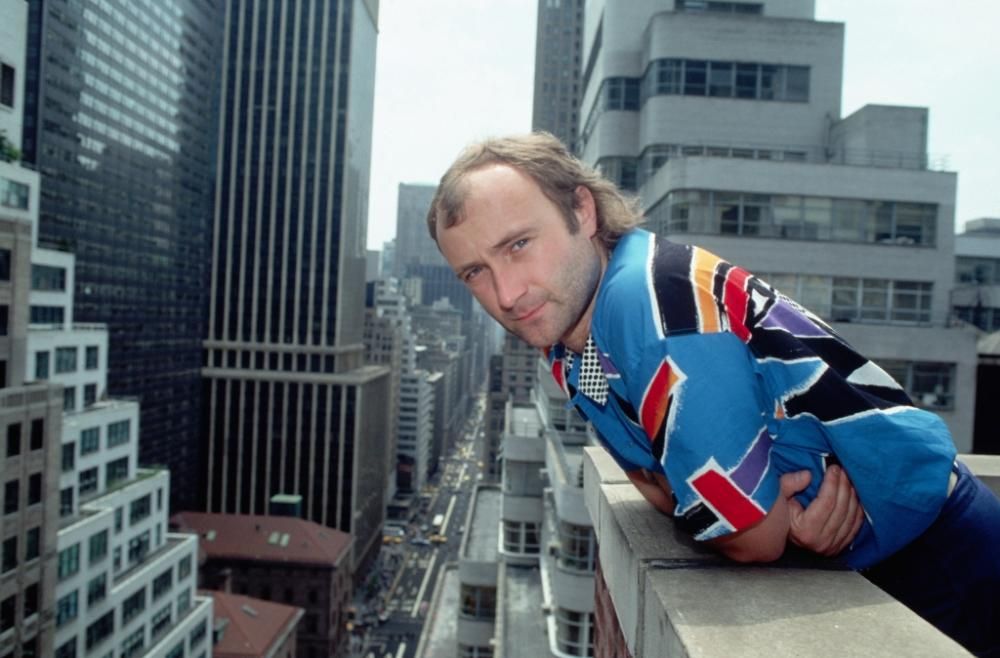 BE084433jpg--phil_collins_standing_on_roof