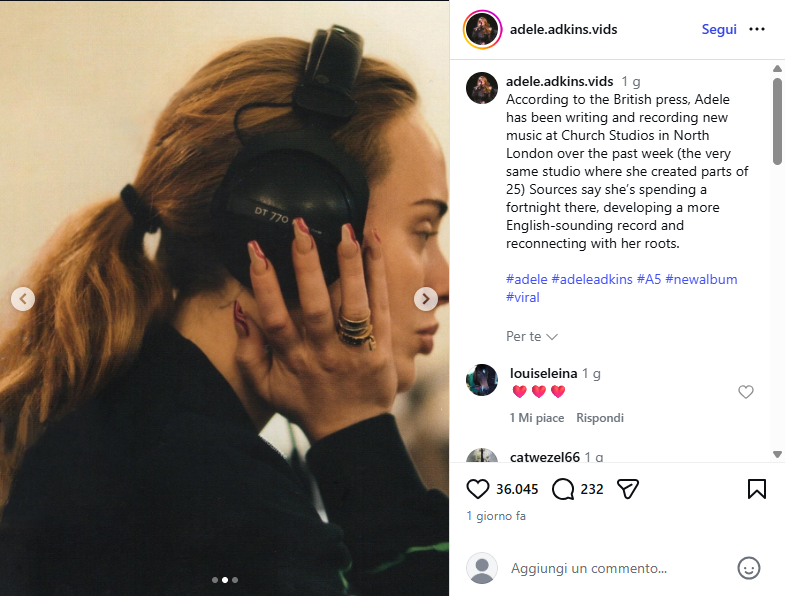 Side profile of a woman with red hair wearing large black over-ear headphones, touching the ear cup with her left hand.