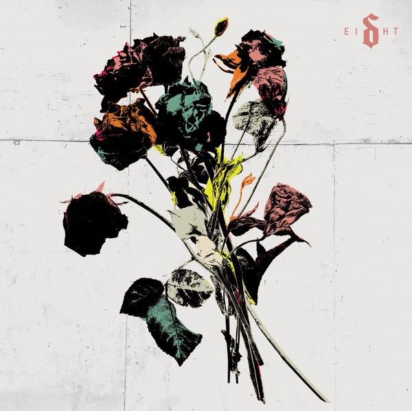 Bouquet of wilted roses in dark, saturated colors against a pale wall, with a small logo in the top-right corner; looks like album art.